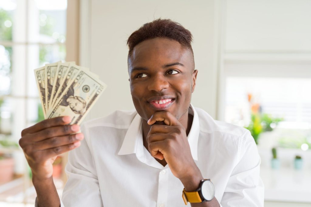 Man holding money and thinking