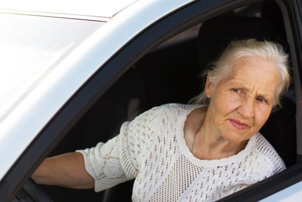 Elderly woman driving car