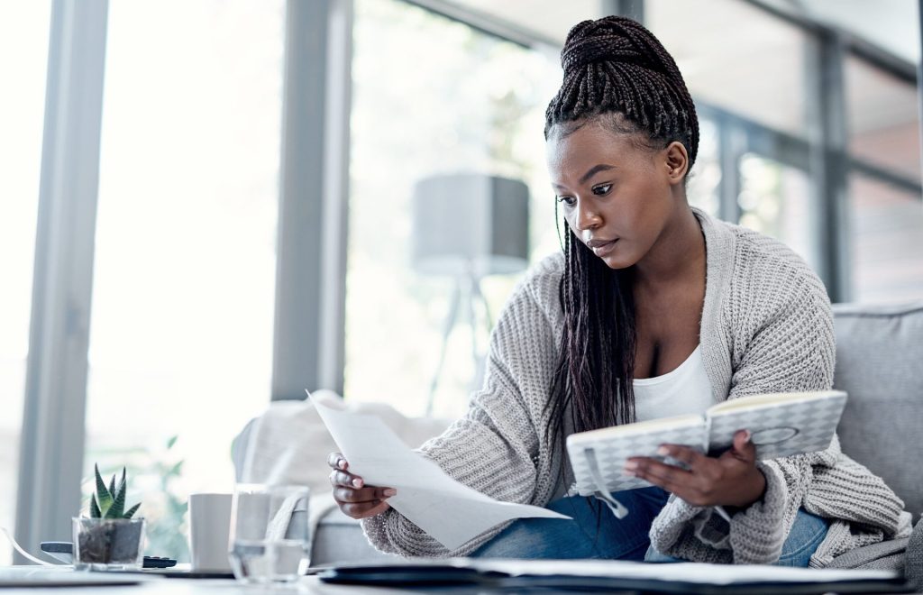 Young woman looking through finances and documents