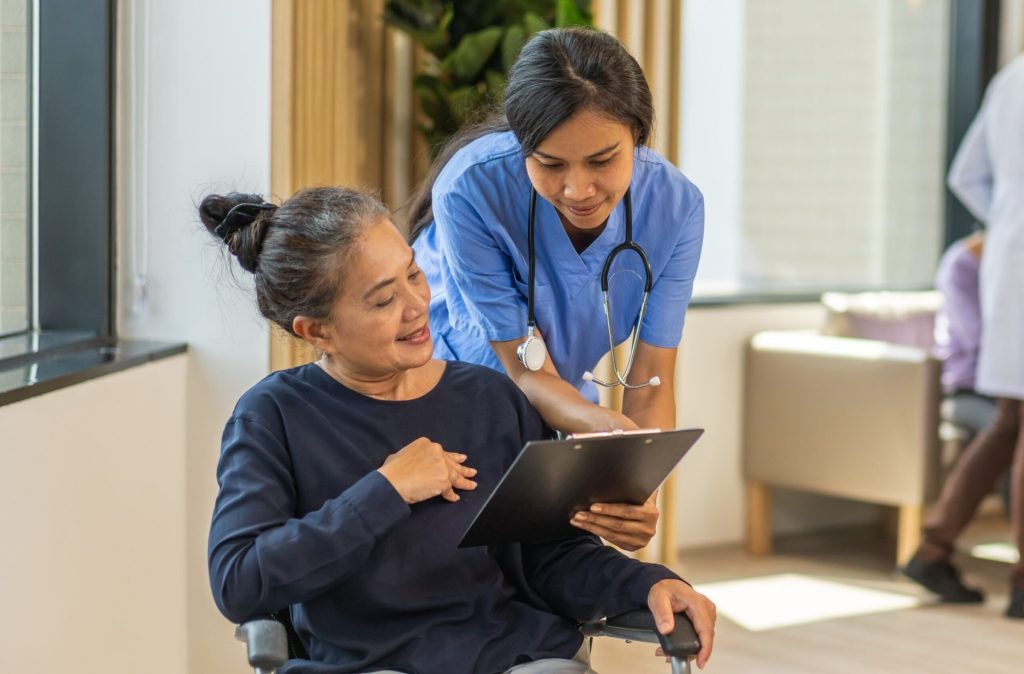 Patient talking to a nurse and looking at a form at a health care clinic