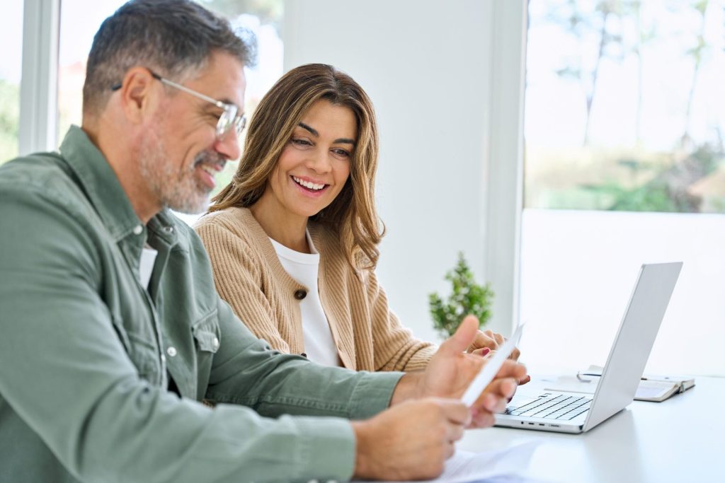 Happy couple looking at their investments