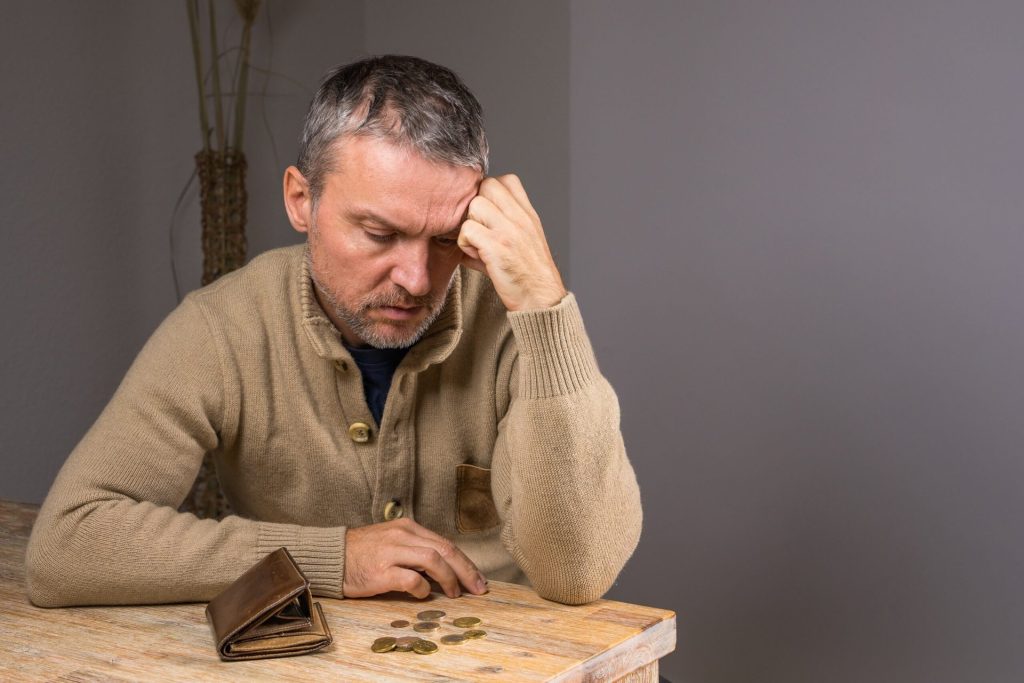 Middle-aged man counting change