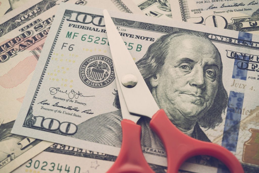 Tax cut concept, with scissors and a $100 bill