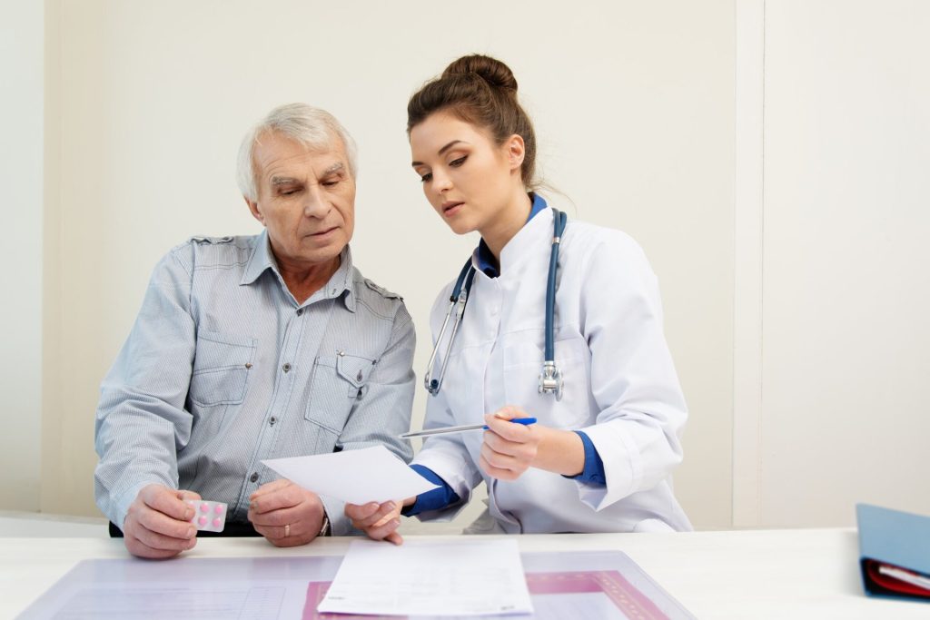 older man talking to doctor getting a prescription
