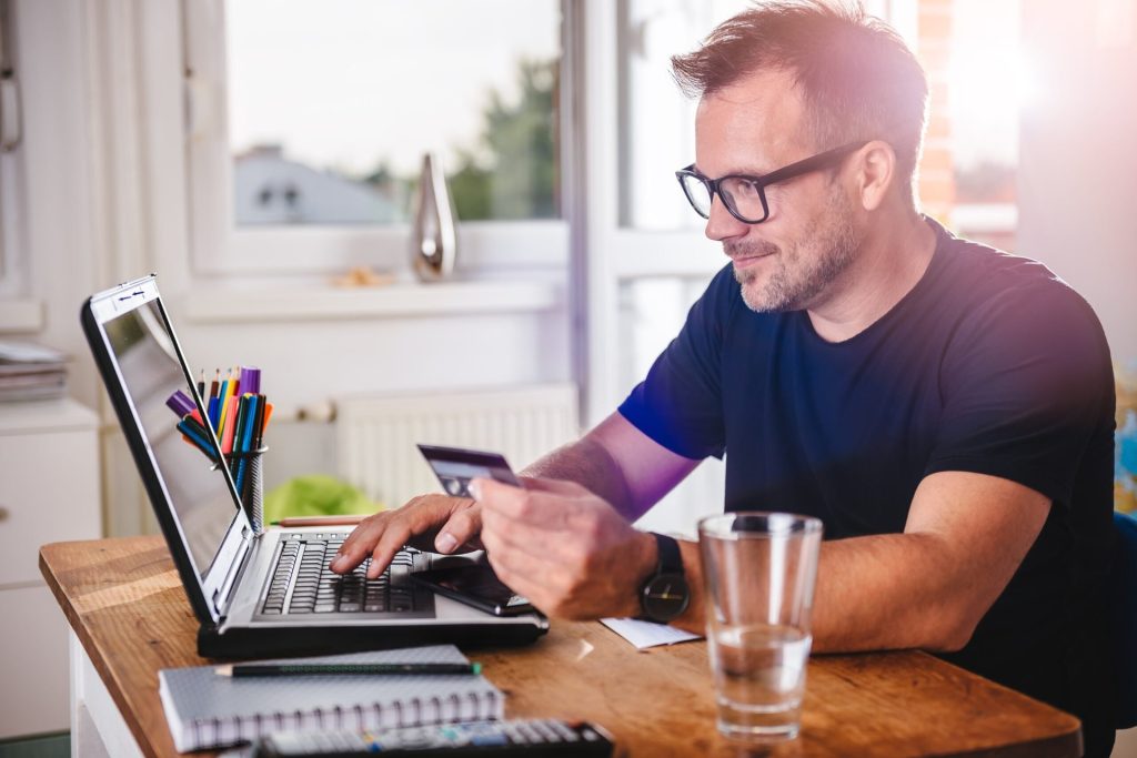 Man using credit card to shop online