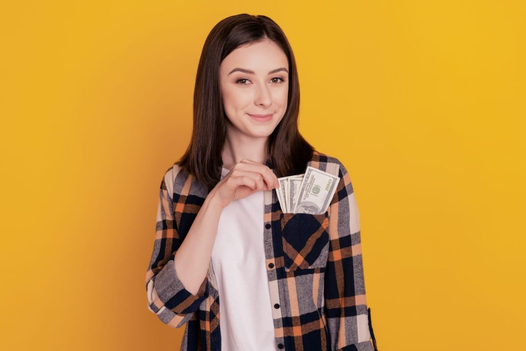 Woman with money in her pocket