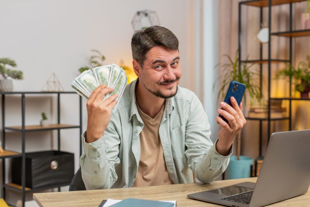 Happy man holding money