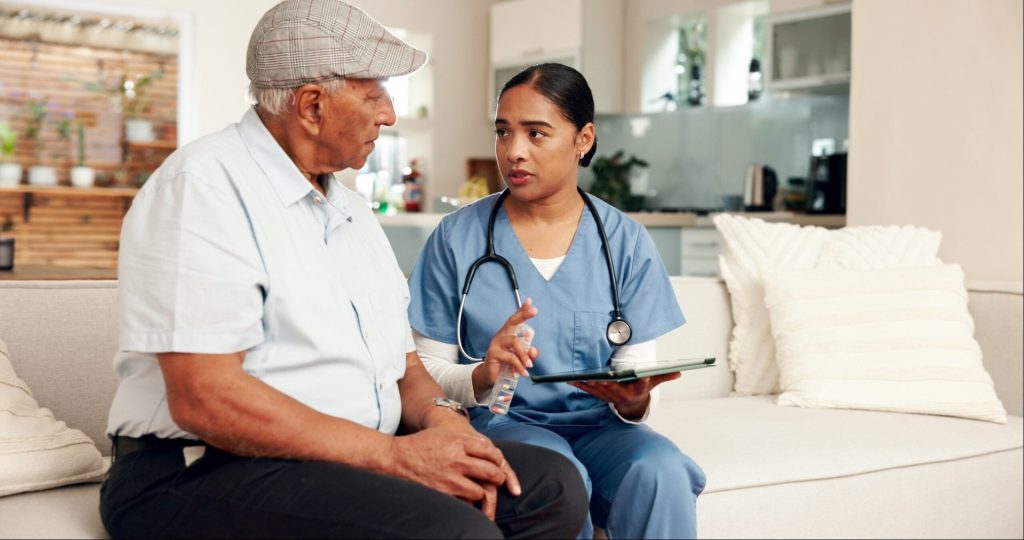 Nurse providing in-home care to older man