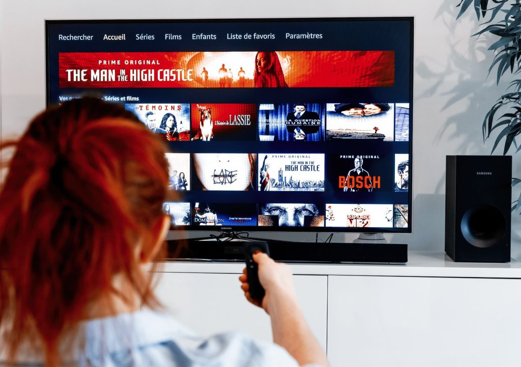 A woman watches Amazon Prime Video on TV at home