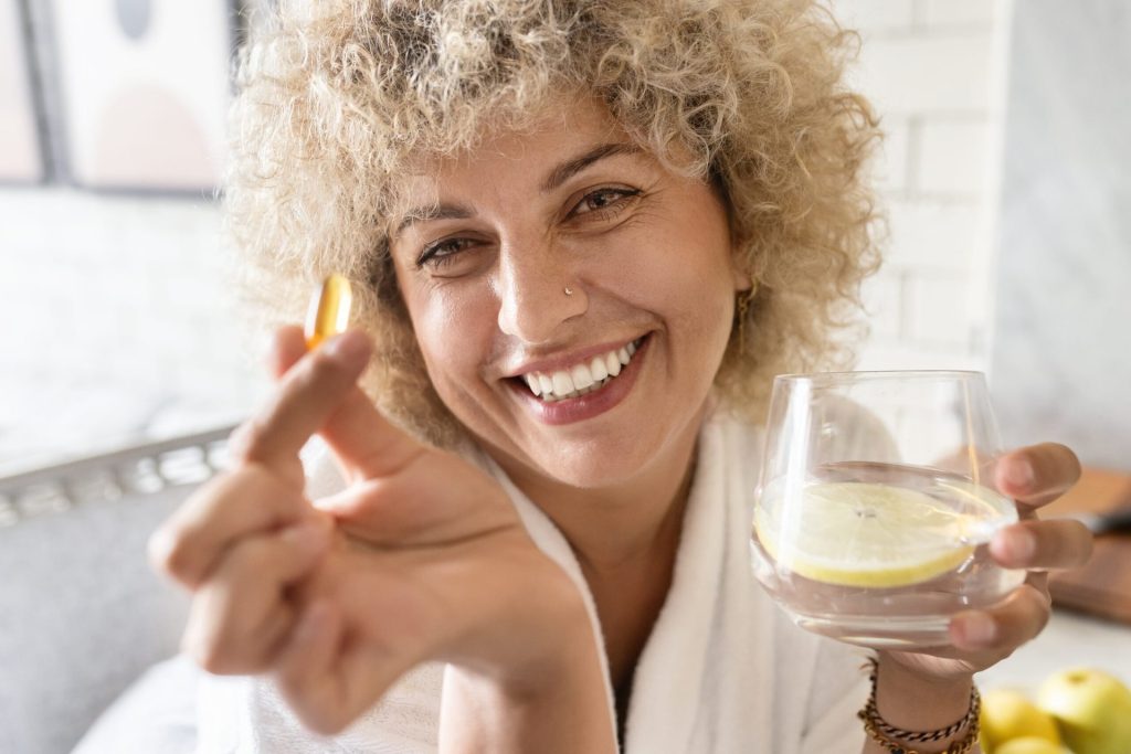Woman taking vitamin supplement.
