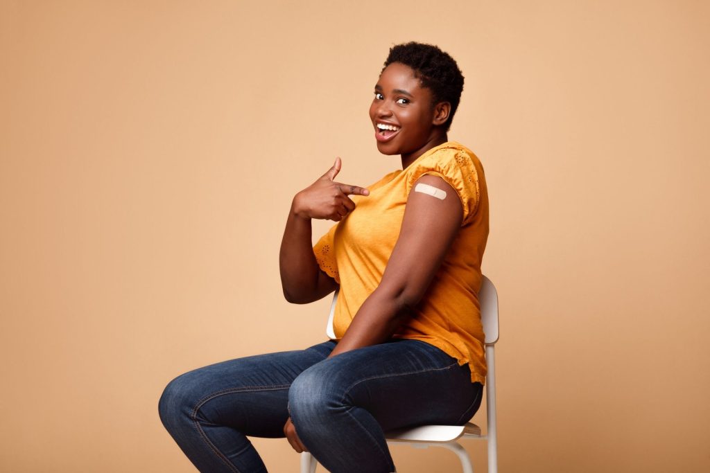 Woman showing off her COVID-19 vaccination