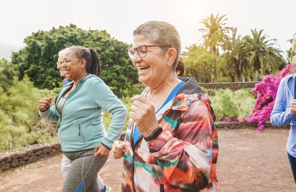 Group of older women working out together outdoors